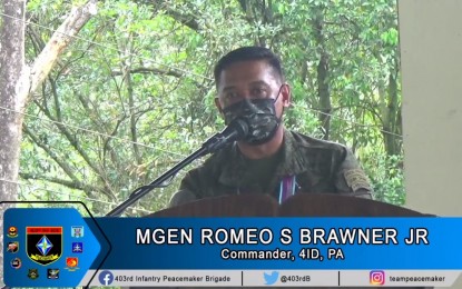 <p><strong>BETTER APPROACH.</strong> Brig. Gen. Romeo S. Brawner Jr., the Army’s 4ID commander, speaks during the program for former rebels who surrendered to the government in Malaybalay City, Bukidnon on Tuesday (Oct. 12, 2021). Brawner said the "whole-of-nation approach" of Executive Order 70, has led to more surrenders from communist guerillas. <em>(Screengrab via 403rd Bde)</em></p>