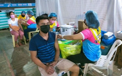 <p><strong>PROTECTED</strong>. A resident of Negros Occidental is being vaccinated against Covid-19 in this undated photo. On Wednesday (April 6, 2022), Governor Eugenio Jose Lacson urged local government units lagging in the Covid-19 vaccination campaign to shape up. <em>(PNA Bacolod file photo)</em></p>
