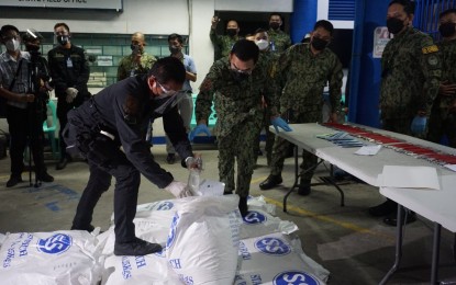 <p><strong>ANTI-TERROR DRIVE.</strong> PNP chief, Gen. Guillermo Eleazar (center) inspects the sacks of ammonium nitrate and blasting caps seized in a joint police and military operation in General Trias City, Cavite on Thursday (Oct. 14, 2021). The seized bomb-making materials have an estimated market value of around PHP200,000. <em>(Photo courtesy of PNP)</em></p>