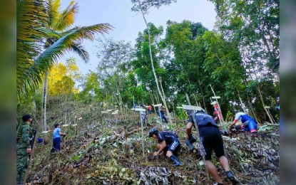 <p><strong>GOING GREEN</strong>. Participants from various organizations plant tree seedlings in Sitio Iyao, Barangay Anticala in Butuan City during the launch of the city police’s “Bike and Plant” program on Saturday (Oct. 16, 2021). The program aims to promote environmental awareness among police personnel, partners, and other stakeholders. <em>(Photo courtesy of BCPO)</em></p>