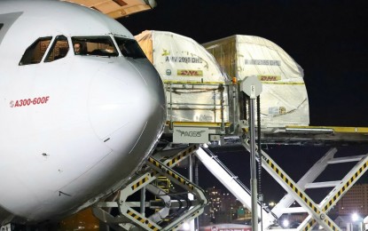 <p><strong>CONTINUOUS VAX ARRIVAL</strong>. Cargo boxes containing 862,290 doses of Pfizer vaccine are unloaded at the Ninoy Aquino International Airport Terminal 3 in Pasay City on Friday (Oct. 15, 2021). National Task Force Against Covid-19 medical adviser Dr. Teodoro Herbosa said eight hospitals in Metro Manila vaccinated 1,153 children less than 18 years old on October 15, using Pfizer. <em>(PNA photo by Robert Oswald P. Alfiler)</em></p>