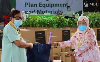 <p><strong>LEARNING MATERIALS.</strong> Deputy Minister Haron Meling (left), of the Ministry of Basic, Higher, and Technical Education in the Bangsamoro Region in Muslim Mindanao, leads the distribution of Learning Continuity Plan equipment and materials Monday (Oct. 18, 2021) at the Cotabato City Schools Division Office. The LCP supplies included computer desktops, digital duplicators, bond papers, teachers’ kits, books, and flashcards, among others.<em> (Photo courtesy of MBHTE-BARMM)</em></p>