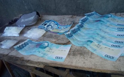 <p><strong>ILLEGAL DRUGS</strong>. About 55 grams of shabu valued at PHP374,000 and drug money seized in one of the drug suspects arrested in Bulacan on Tuesday (Oct. 19, 2021). More than PHP500,000 worth of illegal drugs and 17 suspects were arrested in separate operations in the province on Tuesday and Wednesday. <em>(Photo courtesy of the City of San Jose Del Monte PNP)</em></p>