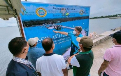 <p><strong>FEEDER PORT</strong>. Sagay City Mayor Alfredo Marañon III discusses the operations of PHP153.5-million Sagay Feeder Port in Negros Occidental with other officials, during its inauguration on Wednesday (October 20, 2021). The World Bank-funded project is expected to benefit more than 22,000 farmers and fisherfolk in northern Negros. <em>(Photo courtesy of Sagay City Information and Tourism Office)</em></p>