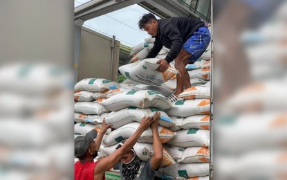 <p><strong>FREE RICE SEEDS.</strong> A truckload of free certified inbred rice seeds for farmers is unloaded in Carmen, Surigao del Sur on Thursday (Oct. 21, 2021) as the yearend rice planting season begins. The Philippine Rice Research Institute – Agusan office has intensified the distribution of certified inbred rice seeds in the Caraga region to help rice farmers increase their production through the high-yielding certified rice seeds. <em>(Photo courtesy of PhilRice-Agusan)</em></p>