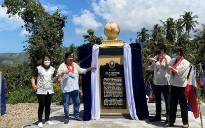 <p><strong>LANDMARK</strong>. Glan, Sarangani Mayor Vivien Yap (second from left), and Tourism Undersecretary Roberto Alabado III (second from right), lead the formal unveiling on Tuesday (Oct. 26, 2021) of the historical landmark in Barangay Batulaki that commemorates the passage in the area exactly 500 years ago of the surviving crew of the Magellan-Elcano expedition. Historical accounts say the ship carrying the Magellan-Elcano expedition dropped anchor on Oct. 26, 1521, at the “Biraham Batolach,” known today as Batulaki. (<em>Photo courtesy of the municipal government</em>) </p>