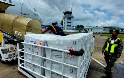 <p><strong>MORE VACCINES.</strong> A police officer checks a shipment of vaccines that arrived at the Tacloban Airport in this Oct. 15, 2021 photo. At least 432,000 minors aged 12 to 17 in Eastern Visayas will be covered in the Covid-19 vaccination drive, the regional health office reported on Friday (Oct. 29, 2021). <em>(Photo courtesy of Civil Aviation Authority of the Philippines)</em></p>