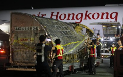 <p><strong>HUNDRED MILLION VAX DOSES.</strong> Air Hongkong flight LD456 carrying some 976,950 doses of Pfizer Covid-19 vaccine lands at the NAIA Terminal 3 Thursday (Oct. 28, 2021) night. The latest vaccine delivery raised to 100,528,240 the number of delivered life-saving shots to the country.<em> (PNA photo by Avito C. Dalan)</em></p>