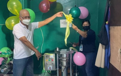 <p><strong>TECHNOLOGY UPGRADE</strong>. Bencals Food Products proprietor Ben Calunod, and DOST Bukidnon Director Ritchie Mae Guno during the turnover of equipment earlier in June 2021. Bencals was recently provided with a PHP625,000 loan to purchase equipment, and this made the enterprise become the first cocoa butter producer in Northern Mindanao. (<em>Photo courtesy of DOST-10</em>) </p>