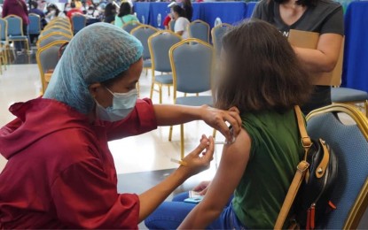 <p><strong>JABBED</strong>. A teenage girl gets inoculated against Covid-19 at the SMX Convention Center vaccination site inside SM City Bacolod on Wednesday (Nov. 3, 2021). On November 5, the city government will start its school-based vaccination to reach more young people in Bacolod. <em>(Photo courtesy of Bacolod City PIO)</em></p>