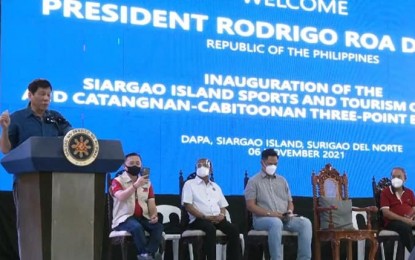 <p><strong>MAJOR PROJECTS.</strong> President Rodrigo Duterte delivers a speech during the inauguration of the Siargao Island Sports and Tourism Complex and the Catangnan-Cabitoonan Bridge Three-Point Bridge System in Siargao Island, Surigao del Norte on Saturday (Nov. 6, 2021). He was accompanied by Senator Christopher “Bong” Go (seated, left).<em> (PCOO photo)</em></p>