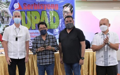 <p><strong>VISIT</strong>. Labor Secretary Silvestre Bello III (2nd from left) receives a token from Negros Occidental Governor Eugenio Jose Lacson (left), in the presence of Vice Governor Jeffrey Ferrer (2nd from right) and Provincial Administrator Rayfrando Diaz II during the distribution of DOLE livelihood assistance at the Negros Residences in Bacolod City on Tuesday (Nov. 9, 2021). Bello led the turn-over of almost PHP18 million worth of financial aid to displaced workers and OFW as well as various cooperatives in the province. <em>(Photo courtesy of PIO Negros Occidental)</em></p>