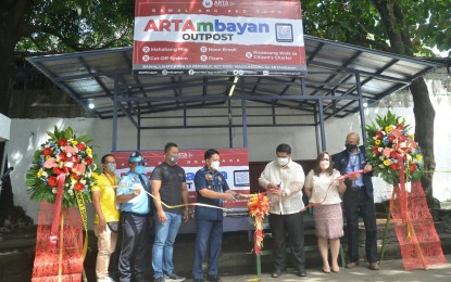 <p><strong>ARTAMBAYAN</strong>. Anti-Red Tape Authority (ARTA) Secretary Jeremiah Belgica (3rd from right) and Maj. Gen. Albert Ignatius Ferro, PNP-Criminal Investigation and Detection Group director (4th from left) lead the ribbon-cutting during the launch of the first ARTAmbayan outpost on Magalang Street, Barangay Pinyahan, Quezon City on Nov. 10, 2021. Also present were other officials from ARTA and the Quezon City government. <em>(PNA photo by Robert Oswald P. Alfiler)</em></p>