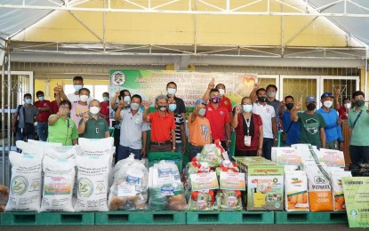 <p><strong>ASSISTANCE</strong>. Farmers and fisherfolk representatives pose in front of some of the agricultural inputs distributed to them by the Pangasinan provincial government Tuesday (Nov. 9, 2021). The distribution was part of the provincial government's Abig (heal) Pangasinan rehabilitation program.<em> (Photo courtesy of Province of Pangasinan)</em></p>