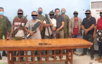 <p><strong>REGAINING WASTED TIME.</strong> Three BIFF fighters turn themselves in with their high-powered firearms to military authorities in Midsayap, North Cotabato on Wednesday (Nov. 10). The surrenderers, joined in this photo by their relatives, said they grew tired of fighting for a lost cause and just wanted to be with their families again. <em>(Photo courtesy of 602Bde)</em></p>