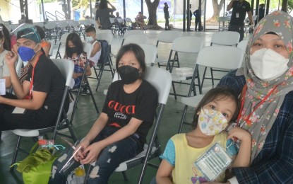 <p><strong>GOING HOME.</strong> Leonida Sevillano (right) and her two children leave Manila en route to Bantayan Island, Cebu on Friday (Nov. 12, 2021). The Balik Probinsya, Bagong Pag-Asa Program will help them settle into a new life. <em>(PNA photo by Robert Oswald Alfiler)</em></p>