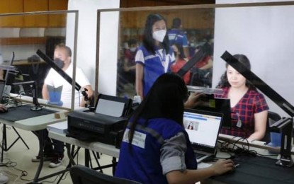 <p><strong>REGISTRATION.</strong> Employees and officials of the Department of Labor and Employment in Davao Region, in coordination with the Philippine Statistics Authority, register for the Philippine Identification card at the DOLE XI Activity Hall in Davao City on Oct. 26, 2021. Regional Director and lawyer Randolf Pensoy said they strictly observed the minimum health protocols throughout the registration process. <em>(Photo courtesy of DOLE-XI)</em></p>