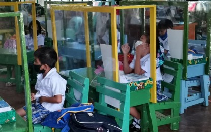 <p><strong>NEW NORMAL.</strong> Students of Napo Elementary School (NES) in Barangay Napo, Linamon, Lanao del Norte are separated by makeshift cubicles as face-to-face classes start on Monday (Nov. 15, 2021). The NES is one of six schools allowed by the Department of Education to pilot in-person classes in the province. <em>(PNA photo by Divina M. Suson)</em></p>