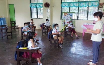 <p><strong>FIRST DAY OF CLASSES</strong>. A teacher at the Buenavista Elementary School in Sorsogon City starts giving her lesson on Monday (Nov. 15, 2021) as part of the pilot implementation of limited face-to-face classes in the country. Nine schools in Bicol region that are situated in remote areas and classified as low-risk for Covid-19 joined the implementation.<em> (Photo courtesy of Department of Education-Bicol)</em></p>