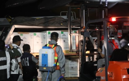 <p><strong>US DONATION.</strong> The boxes containing 301,860 doses of Pfizer vaccine are unloaded from the plane Monday night (Nov. 15, 2021) at the NAIA Terminal 3 in Pasay City. This latest vaccine shipment is donated by the US government through the COVAX Facility. <em>(PNA photo by Avito Dalan)</em></p>