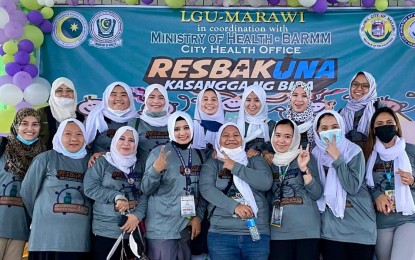 <p><strong>FRONT-LINERS.</strong> Health care workers pose for posterity during the launch of the pediatric vaccination at the Amai Pakpak Central Elementary School in Marawi City in this November 2021 photo. Officials said the Bangsamoro Autonomous Region in Muslim Mindanao has the lowest turnout of vaccinees so far, with just 11 percent of the target population getting full doses so far. <em>(Photo courtesy of Sam Ar Dee/Marawi City Health Office)</em></p>