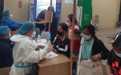 <p><strong>SERVICE.</strong> Wearing protective suits, staff of the Overseas Workers Welfare Administration Region 10 assist returning overseas Filipino Workers at the Laguindingan International Airport, Misamis Oriental on Friday (Nov. 19, 2021). From January to November this year, the agency has already repatriated 27,420, all expenses paid. <em>(Photo courtesy of OWWA-10)</em></p>