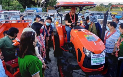 <p><strong>DISTRIBUTION</strong>. A Department of Agrarian Reform official tests the tractor distributed to agrarian reform beneficiary organizations in Pangasinan on Nov. 23, 2021. The farm machinery and farm inputs given cost PHP10.58 million. <em>(PNA file photo courtesy of Jhon Macaranas Caranto)</em></p>