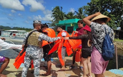 <p><strong>SAFETY OF TOURISTS.</strong> Personnel from the MDRRMO of Del Carmen in Siargao Island, Surigao del Norte, with the support of the Philippine Coast Guard, provide security assistance to visiting tourists through the Malasakit Help Desk. Foreign and local tourists start to visit the town as Siargao Island opened its tourism activities. <em>(Photo courtesy of MDRRMO Del Carmen)</em></p>