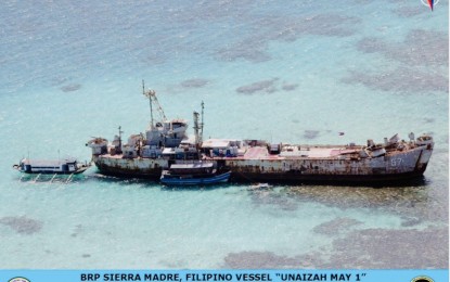 <p><strong>RESUPPLY MISSION.</strong> Two resupply boats dock in front and beside the BRP Sierra Madre at the Ayungin Shoal in the West Philippine Sea on Tuesday (Nov. 23, 2021). Defense Secretary Delfin Lorenzana said Chinese Ambassador Huang Xilian vowed to look into the alleged act of intimidation by the Chinese Coast Guard where personnel on a rubber boat took pictures and videos of Manila's resupply mission. <em>(Photo courtesy of DND)</em></p>