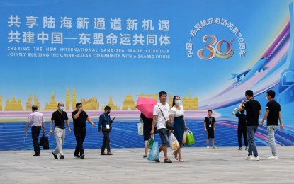 <p><strong>CHINA-ASEAN</strong>. People walk out of the venue of the 18th China-Asean Expo in Nanning, capital of south China's Guangxi Zhuang Autonomous Region on Sept. 13, 2021. China remained Asean's largest trading partner for 12 consecutive years. <em>(Xinhua/Lu Boan)</em></p>