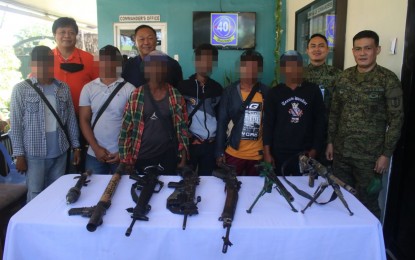 <p><strong>DISMAYED AND EXHAUSTED</strong>. Six BIFF surrenderers present the guns they turned over after yielding to the Army’s 40th Infantry Battalion in Datu Paglas, Maguindanao on Wednesday (Nov. 24, 2021). The surrenderers said they felt neglected in the field by their leaders amid the intense military pursuit operations against them. <em>(Photo courtesy of 40IB)</em></p>