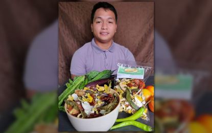 <p><strong>INNOVATION</strong>. Allan Padilla, president of the 4H AgriKuli Dinalaoan Club in Calasiao town, Pangasinan, turns vegetables into nutritious chips together with the other youths in his community. Padilla used the grant assistance he received from the Department of Agriculture to buy the needed machines for their production. <em>(Photo courtesy of Gerald Quinit)</em></p>