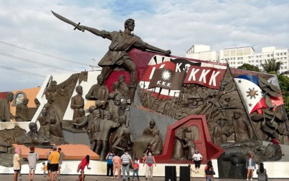 <p><strong>HERO.</strong> Families and groups take souvenir photos in front of the Kartilya ng Katipunan monument near the Manila City Hall on Monday (Nov. 29, 2021). The nation will commemorate on Tuesday (November 30) the 158th birth anniversary of the Tondo-born hero, Andres Bonifacio, who is known as the Father of the Philippine Revolution. <em>(PNA photo by Ben Briones)</em></p>