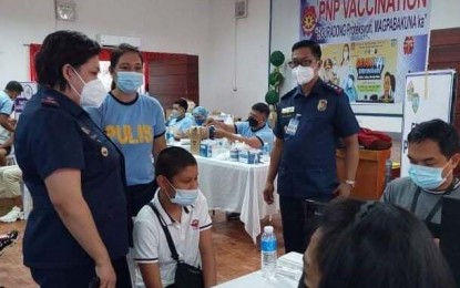 <p><strong>VAX FOR COPS' KIN</strong>. Dependents of Police Regional Office in Bicol (PRO5) personnel receive their Covid-19 vaccine shots at Camp Simeon Ola in Legazpi City on Monday (Nov. 29, 2021). Maj. Malu Calubaquib, PRO5 spokesperson, said the Bicol police is one with the government in its desire to protect more people against the virus during the three-day 'Bayanihan Bakunahan' program. <em>(Photo courtesy of PRO5 Information Office)</em></p>