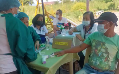 <p>Barangay health workers among the health personnel who administer vaccines to villagers in Samal town, Bataan province.<em> (File photo by Ernie Esconde)</em></p>
