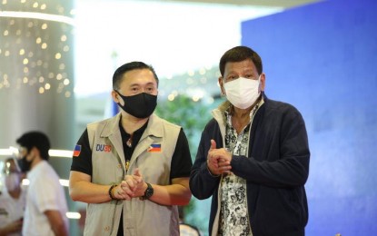 <p><strong>OUT.</strong> Senator Christopher Lawrence “Bong” Go (left) accompanies President Rodrigo Duterte to witness vaccination activities at a mall in Antipolo on Monday (Nov. 29, 2021). On Tuesday (Nov. 30, 2021), he announced his withdrawal from the presidential race, saying it may not be his time yet to lead the country. <em>(Photo courtesy of SBG Facebook)</em></p>