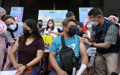 <p><strong>LIFE-SAVING SHOT.</strong> Vaccination against the coronavirus is in full swing, with Health Sec. Francisco Duque III taking the lead in administering the life-saving shot.  The year 2021 is full of hope for a pandemic-weary nation like the Philippines when vaccines started to arrive and more Filipinos get protected against the coronavirus. <em>(File photo)</em></p>