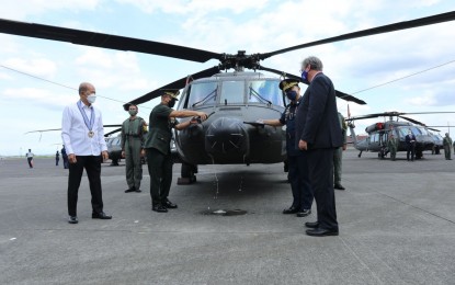 <p><strong>NEW HELICOPTERS.</strong> Defense Secretary Delfin Lorenzana (left) graces the turnover ceremony of the five brand-new Sikorsky S-71i "Black Hawk" combat utility helicopters at the Clark Air Base, Angeles City, Pampanga on Dec. 3, 2021. Lorenzana on Sunday (Dec. 5, 2021) said the five new helicopters will further improve the lift capability of the Philippine Air Force to support various operations of the Armed Forces of the Philippines. <em>(Photo courtesy of Defense Secretary Delfin Lorenzana Facebook page)</em></p>
