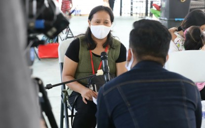 <p><strong>HOPE FOR AN ENTREPRENEUR</strong>. Diane Carol Elumba, 36, shares her experience on how her food shop struggled with the pandemic's impact, in an interview at the BP2 depot in Quezon City on Monday (Dec. 6, 2021). Her family is among the 13 families set to depart to their respective provinces on Dec. 7. (<em>PNA photo by Robert Oswald P. Alfiler</em>)</p>