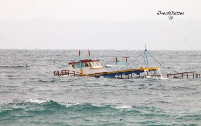 <p><strong>SEA MISHAP</strong>. The sinking boat M/V Noah Akim is seen off the coast of Capul, Northern Samar in this photo taken on Tuesday (Dec. 7, 2021). All 14 crew members survived the sea mishap, the Philippine National Police reported on Wednesday. <em>(Photo courtesy of Drew Diaries TV)</em></p>