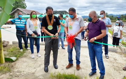 <p><strong>SOLAR DRYER.</strong> Mayor Symond Caguit (center), Department of Agrarian Reform (DAR) Caraga Regional Director Leomides Villareal (right), and DAR Agusan Sur Provincial Officer Jamil Amatonding (3rd from right) formally open the newly-completed solar dryer in Barangay Sayon, Sta. Josefa, Agusan del Sur on Dec. 9, 2021. The DAR handed over three solar dryers worth PHP2.28 million that will benefit around 292 rice farmers in the town. <em>(Photo courtesy of DAR Caraga)</em></p>