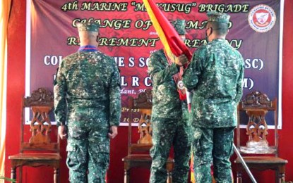 <p><strong>NEW COMMANDER.</strong> Maj. Gen. Ariel Caculitan, Philippine Marine Corps commandant, hands over the command flag to Col. Vicente Mark Anthony Blanco III (right), who was installed as the new commander of the Sulu-based 4th Marine Brigade on Friday (Dec. 10, 2021). Blanco replaced Col. Hernanie Songano in one of the units of the Joint Task Force - Sulu fighting the Abu Sayyaf Group in the province. <em>(Photo courtesy of JTF-Sulu PAO)</em></p>