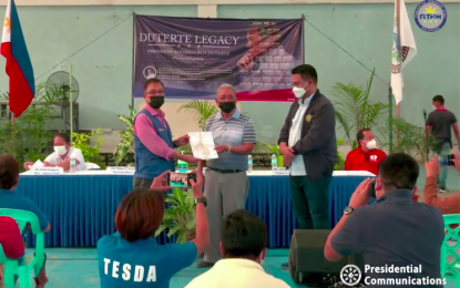 <p><strong>SCHOLARSHIP GRANTS.</strong> TESDA-Negros Oriental provincial director Joel Villagracia (left) hands over scholarship grants to Mayor Edgar Teves of Valencia, Negros Oriental in the presence of PCOO Secretary Martin Andanar. The activity held on Monday, (Dec. 13, 2021) is in line with the Duterte Legacy Caravan that raises awareness on the accomplishments of the Duterte administration.<em> (Screen grab from RTVM live streaming)</em></p>