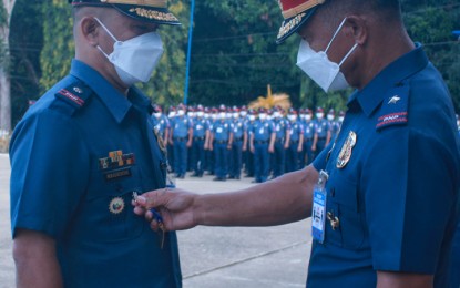 <p><strong>POLICE MEDAL AWARDEE.</strong> Brig. Gen. Victor Wanchakan (right), PRO-9 deputy director for administration, pins the Medalya ng Kagalingan on Maj. Mario Regidor (left) on Monday (Dec. 13, 2021) for the latter's accomplishment in the campaign against wanted persons in the region. Regidor is one of the six policemen the Police Regional Office-9 awarded with medals for exemplary performance of duty. <em>(Photo courtesy of PRO-9)</em></p>