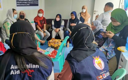 <p><strong>WOMEN, KIDS PROTECTION.</strong> United Nations Population Fund (UNFPA) country representative Dr. Leila Joudane (far left, white veil) talks to leaders of various women’s groups during her visit to Sultan Kudarat, Maguindanao on Sunday (Dec. 12, 2021). The UN envoy visited the town as one of the highlights in her visit in pushing to end violence against women and children. <em>(Photo courtesy of (UNFPA)</em></p>