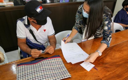 <p><strong>'BALIK PROBINSYA'</strong>. Undated photo shows Jose Pableo, 66, a “Balik Probinsya, Bagong Pag-asa” (BP2) beneficiary in Cabusao, Camarines Sur as he receives livelihood settlement grant for his “sari-sari” store. The BP2 program is one of the government's support measures to decongest urban poor communities. <em>(Photo courtesy of Ram Joseph S. Zaragoza/DSWD-Bicol)</em></p>