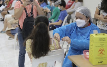 <p><strong>PEDIATRIC VACCINATION.</strong> A young female vaccinee receives her protection against the coronavirus at the capitol compound of Batangas City on Tuesday (Dec. 14, 2021). Booster shots for front-liners and the immunocompromised sector were also administered.<em> (Photo courtesy of Batangas-PIO)</em></p>