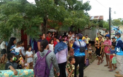 <p><strong>OFF TO SAFER GROUNDS</strong>. Lapu-Lapu City Disaster Risk Reduction and Management officers assist residents of low-lying villages in transferring to nearby public schools or gymnasiums on Thursday (Dec. 16, 2021). At least 3,987 individuals were evacuated as a preemptive measure amid the threat posed by Typhoon Odette.<em> (Photo courtesy of Nagiel Bañacia)</em></p>