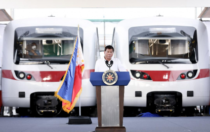 <p><strong>NEW TRAIN SETS FOR MRT-7</strong>. President Rodrigo R. Duterte delivers his speech during the unveiling of brand-new train sets for the Metro Rail Transit Line 7 (MRT-7) along Commonwealth Avenue in Diliman, Quezon City on Thursday (Dec. 16, 2021).  Duterte said the national government will ensure that the MRT-7 will be “partially operational” by the fourth quarter of 2022. <em>(Presidential photo by Alberto Alcain)</em></p>