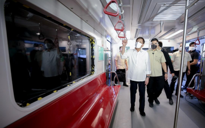 <p><strong>NEW TRAINS.</strong> President Rodrigo Duterte inspects the brand new trains of the Metro Rail Transit Line 7 (MRT-7) after leading the unveiling ceremony at the MRT-7 tracks along Commonwealth Avenue in Diliman, Quezon City on Dec. 16, 2021. Improvements in the transport sector are part of the Duterte administration's massive Build, Build, Build program. <em>(Presidential photo by Arman Baylon)</em></p>